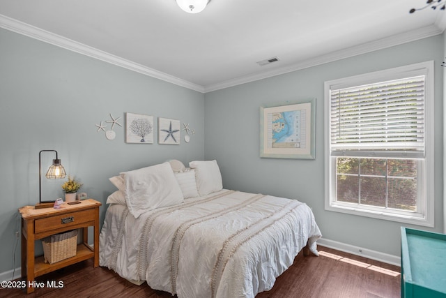 bedroom featuring visible vents, ornamental molding, and wood finished floors