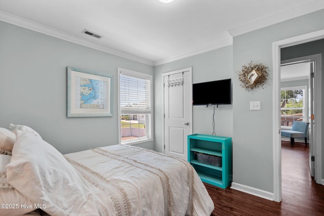 bedroom with crown molding, baseboards, visible vents, and dark wood-style floors