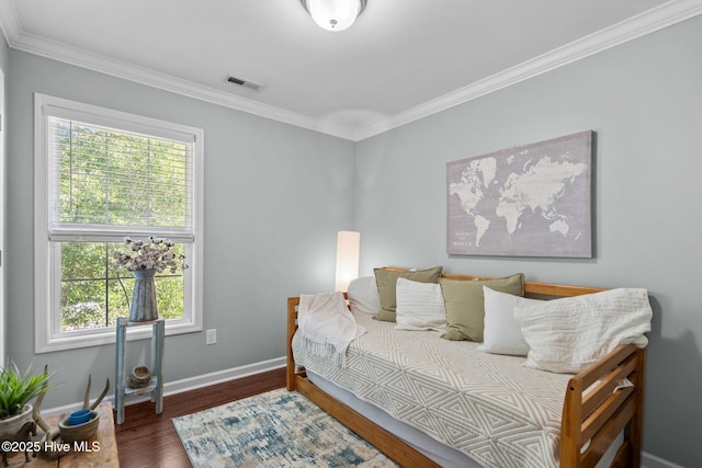 bedroom with crown molding, visible vents, and multiple windows