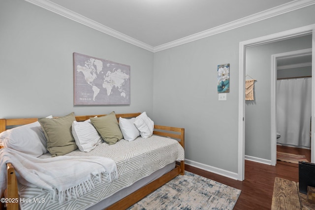 bedroom featuring crown molding, baseboards, and wood finished floors