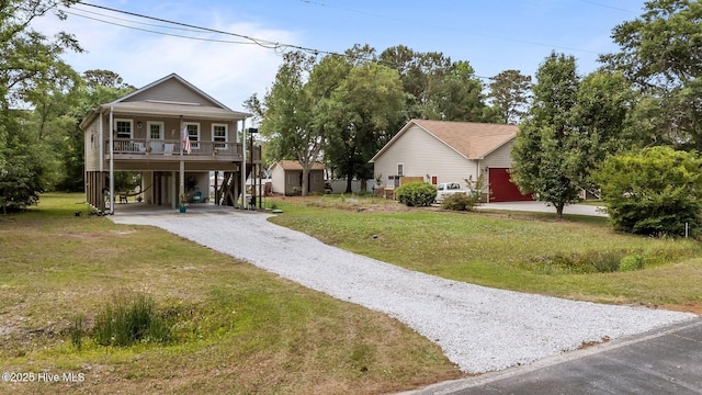 1326 Burnett Rd, Wilmington, NC 28409 - view of front of home with a carport, gravel driveway, a front yard, and a porch