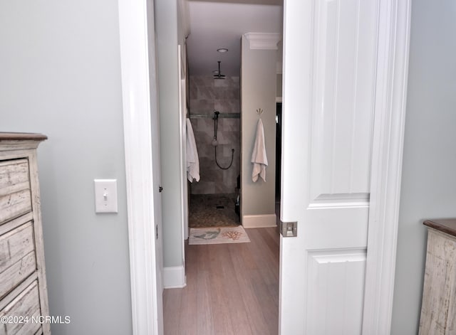 full bathroom featuring baseboards, a shower stall, and wood finished floors