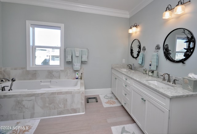 full bath featuring a garden tub, a sink, double vanity, and ornamental molding