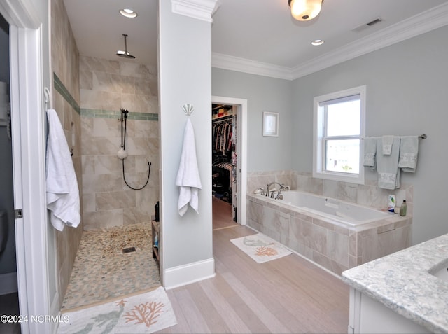 full bath with a garden tub, walk in shower, wood finished floors, and visible vents