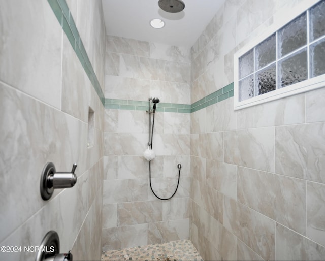 bathroom with a tile shower