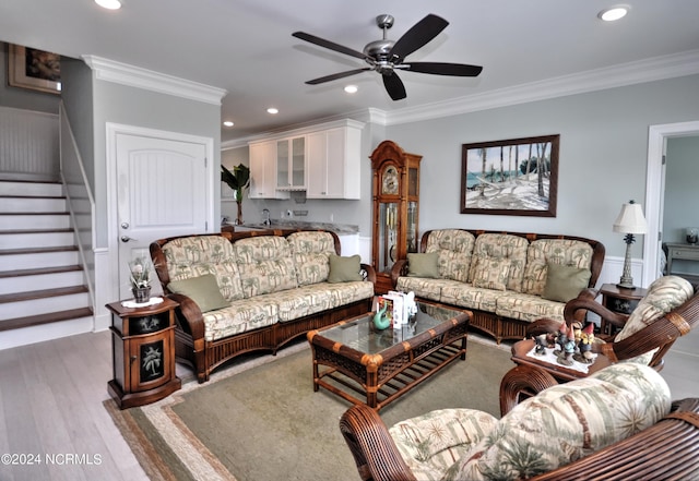 living room featuring stairs, a ceiling fan, recessed lighting, and ornamental molding