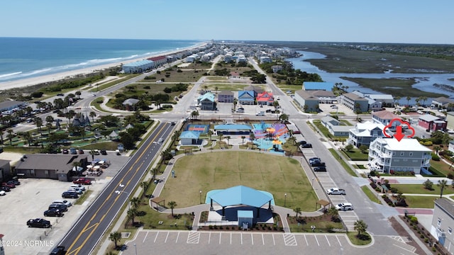 birds eye view of property featuring a water view and a view of the beach