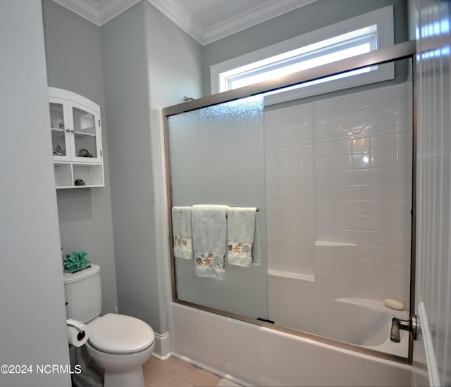 full bathroom with crown molding, wood finished floors, baseboards, combined bath / shower with glass door, and toilet