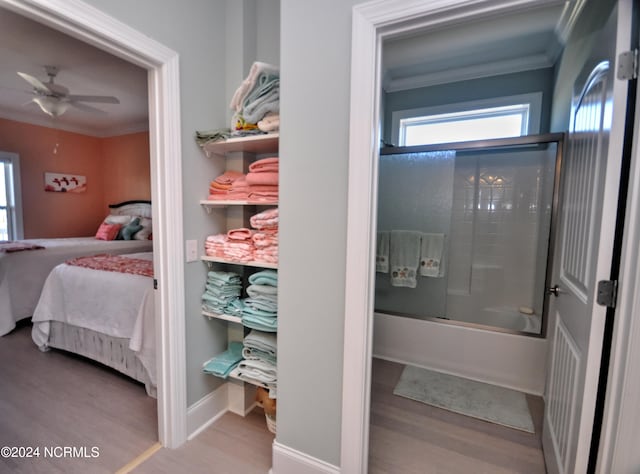 interior space featuring crown molding, wood finished floors, and ensuite bath