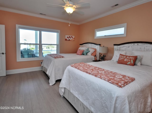 bedroom featuring multiple windows, wood finished floors, and visible vents