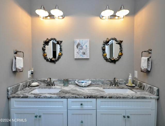 full bathroom featuring double vanity and a sink