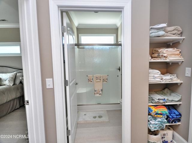 bathroom featuring visible vents, ornamental molding, and a stall shower