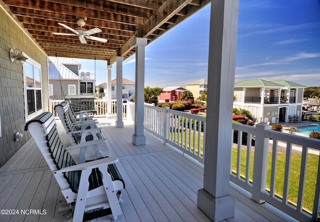 wooden deck featuring a residential view and a ceiling fan