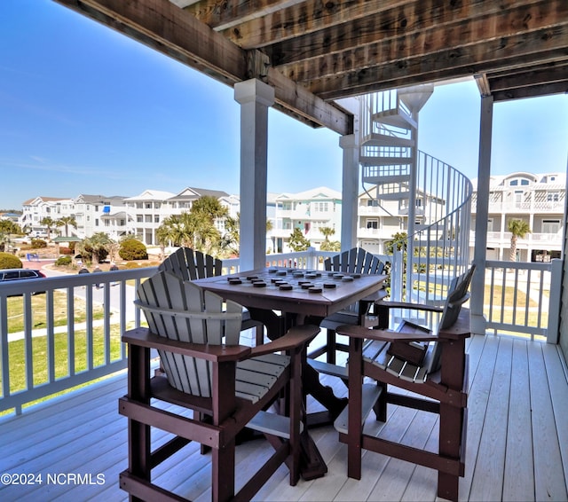 wooden deck featuring stairway and a residential view