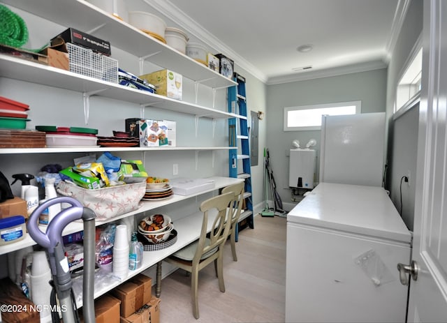 laundry room with laundry area, ornamental molding, light wood finished floors, and independent washer and dryer