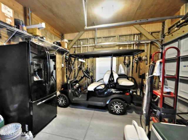 garage with black fridge