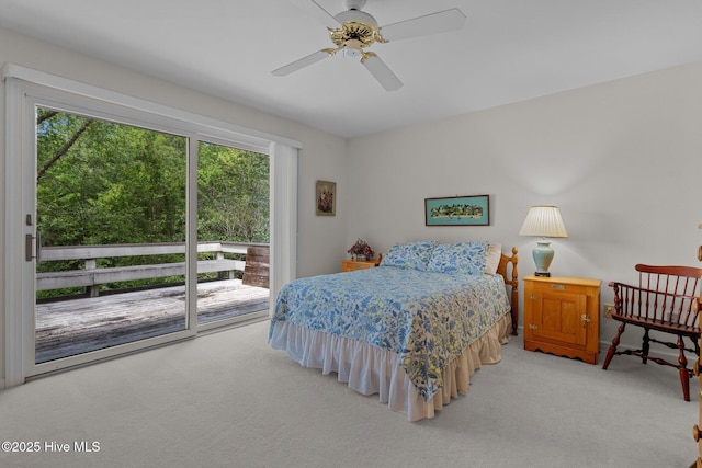 bedroom featuring access to outside, light carpet, and a ceiling fan