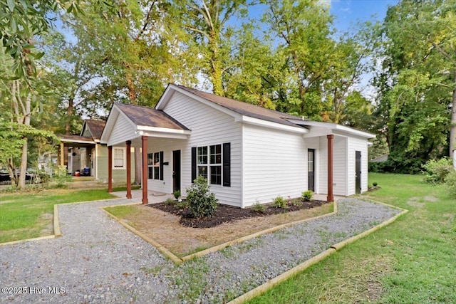 view of side of property with a yard and a patio area