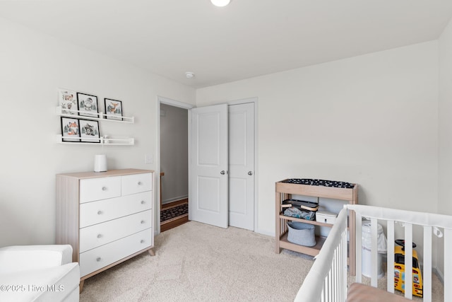 bedroom with light carpet and a crib