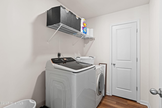 laundry room featuring washer and dryer, laundry area, and dark wood-type flooring