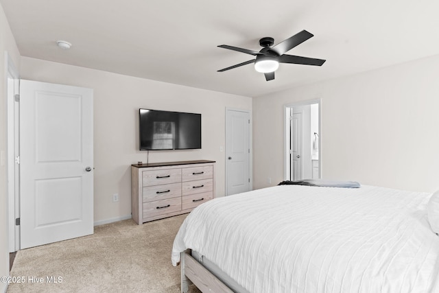 bedroom with light colored carpet, baseboards, and ceiling fan