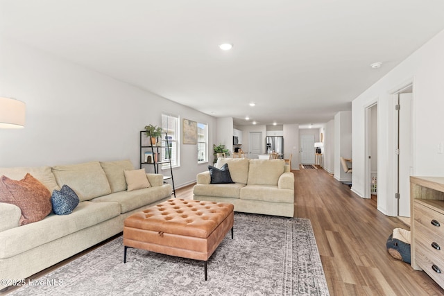 living area with recessed lighting, baseboards, and wood finished floors