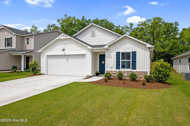 view of front of home with board and batten siding, an attached garage, driveway, and a front yard