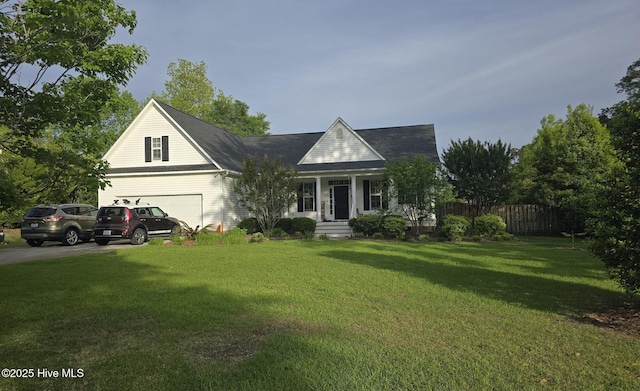 view of front facade featuring covered porch, fence, driveway, and a front yard