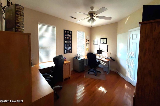 office space featuring visible vents, light wood-style flooring, ceiling fan, and a healthy amount of sunlight