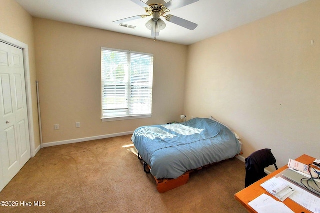 carpeted bedroom featuring visible vents, baseboards, and ceiling fan