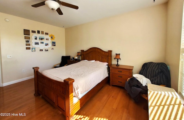 bedroom featuring baseboards, ceiling fan, and light wood finished floors