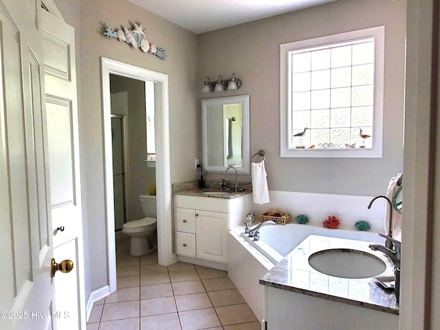 bathroom with two vanities, a sink, tile patterned flooring, and a garden tub