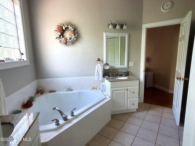 bathroom featuring vanity, a bath, and tile patterned flooring
