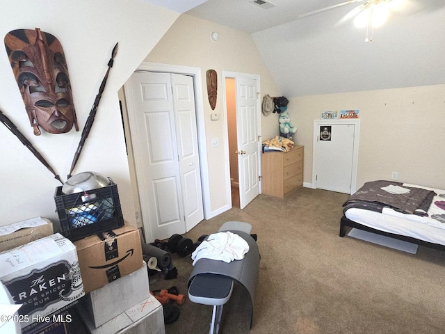 carpeted bedroom featuring ceiling fan, vaulted ceiling, visible vents, and a closet