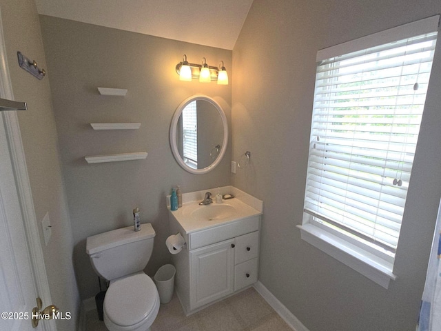 bathroom with vanity, tile patterned flooring, and toilet