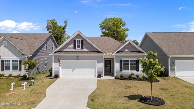 craftsman-style house with driveway, roof with shingles, and a front lawn