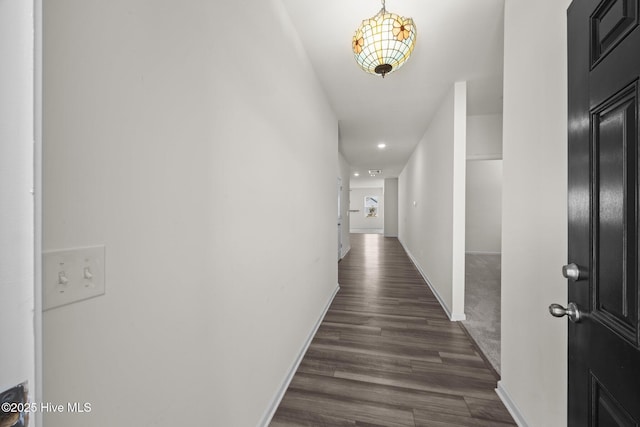hall with recessed lighting, baseboards, and dark wood-style flooring