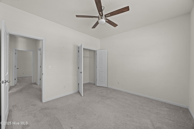 unfurnished bedroom featuring light colored carpet, a ceiling fan, and baseboards