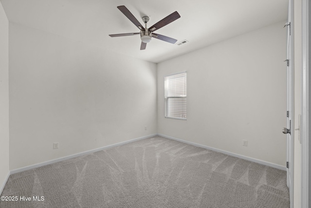 spare room with carpet floors, a ceiling fan, baseboards, and visible vents