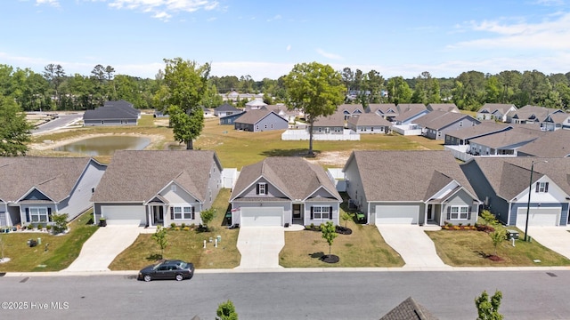 bird's eye view featuring a residential view and a water view