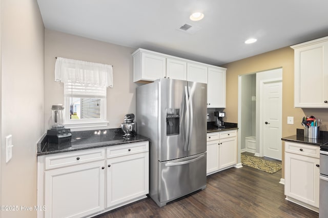 743 Heather Glen Ln, Calabash, NC 28467 - kitchen featuring dark stone countertops, stainless steel refrigerator with ice dispenser, recessed lighting, white cabinetry, and dark wood-style floors