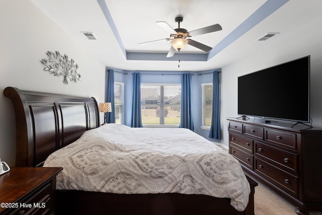 743 Heather Glen Ln, Calabash, NC 28467 - bedroom featuring light colored carpet, a raised ceiling, a ceiling fan, and visible vents