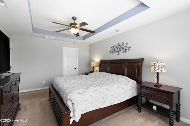 743 Heather Glen Ln, Calabash, NC 28467 - bedroom featuring a tray ceiling, light carpet, baseboards, and visible vents