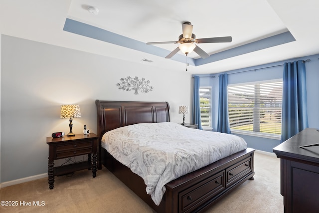 743 Heather Glen Ln, Calabash, NC 28467 - bedroom featuring baseboards, light carpet, a tray ceiling, and visible vents