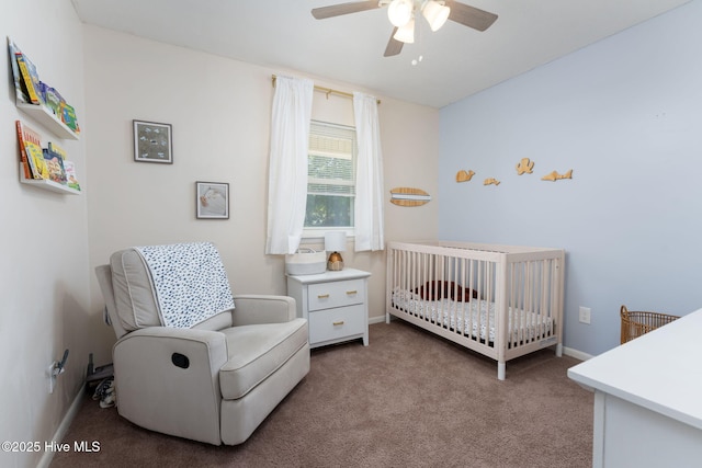 bedroom with carpet flooring, a nursery area, baseboards, and a ceiling fan