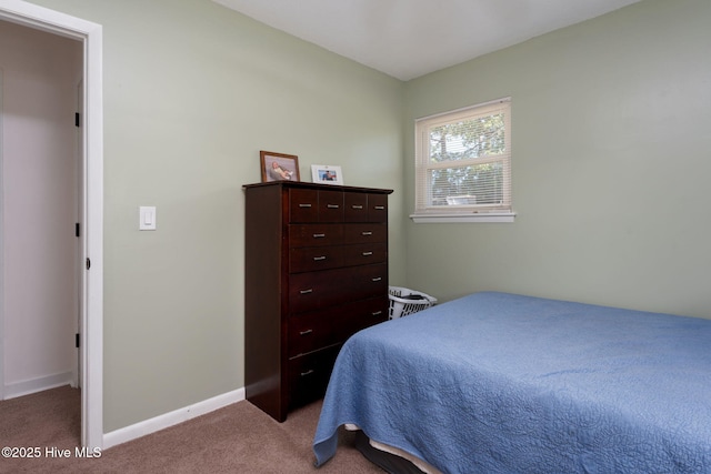 carpeted bedroom featuring baseboards