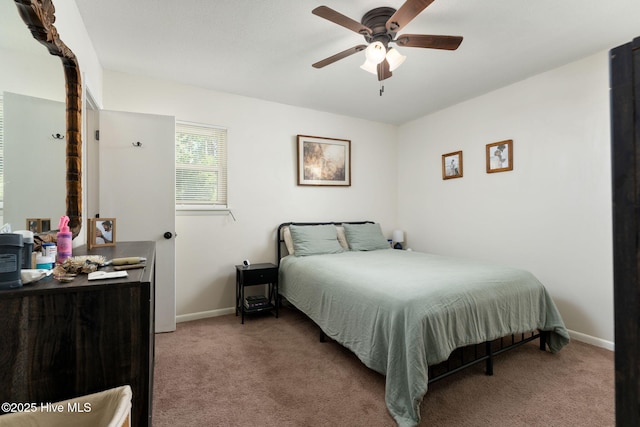bedroom featuring baseboards, light colored carpet, and ceiling fan