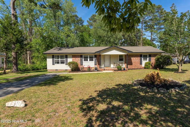 ranch-style house featuring a shingled roof, a front lawn, brick siding, crawl space, and covered porch