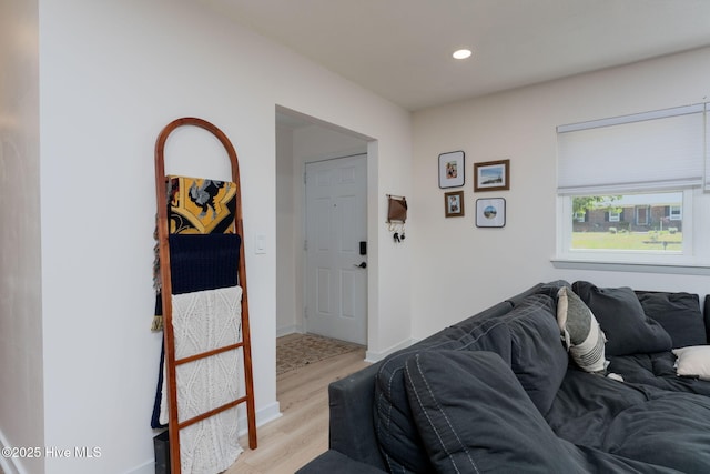 living room with light wood-type flooring, recessed lighting, and baseboards