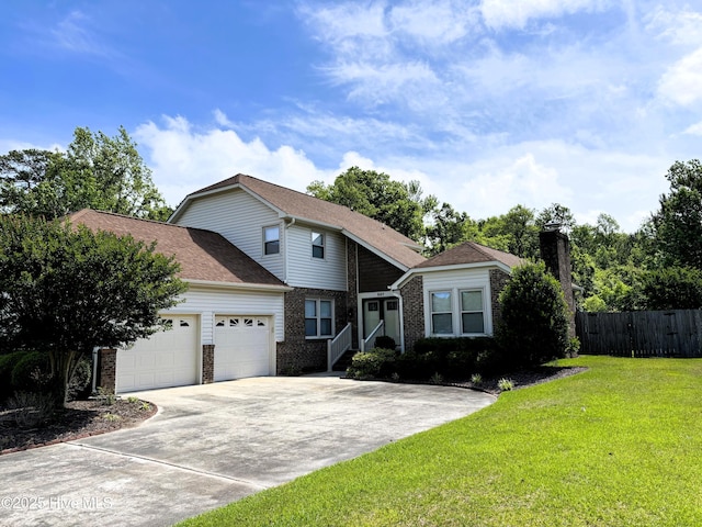 traditional home featuring a chimney, fence, an attached garage, concrete driveway, and a front lawn